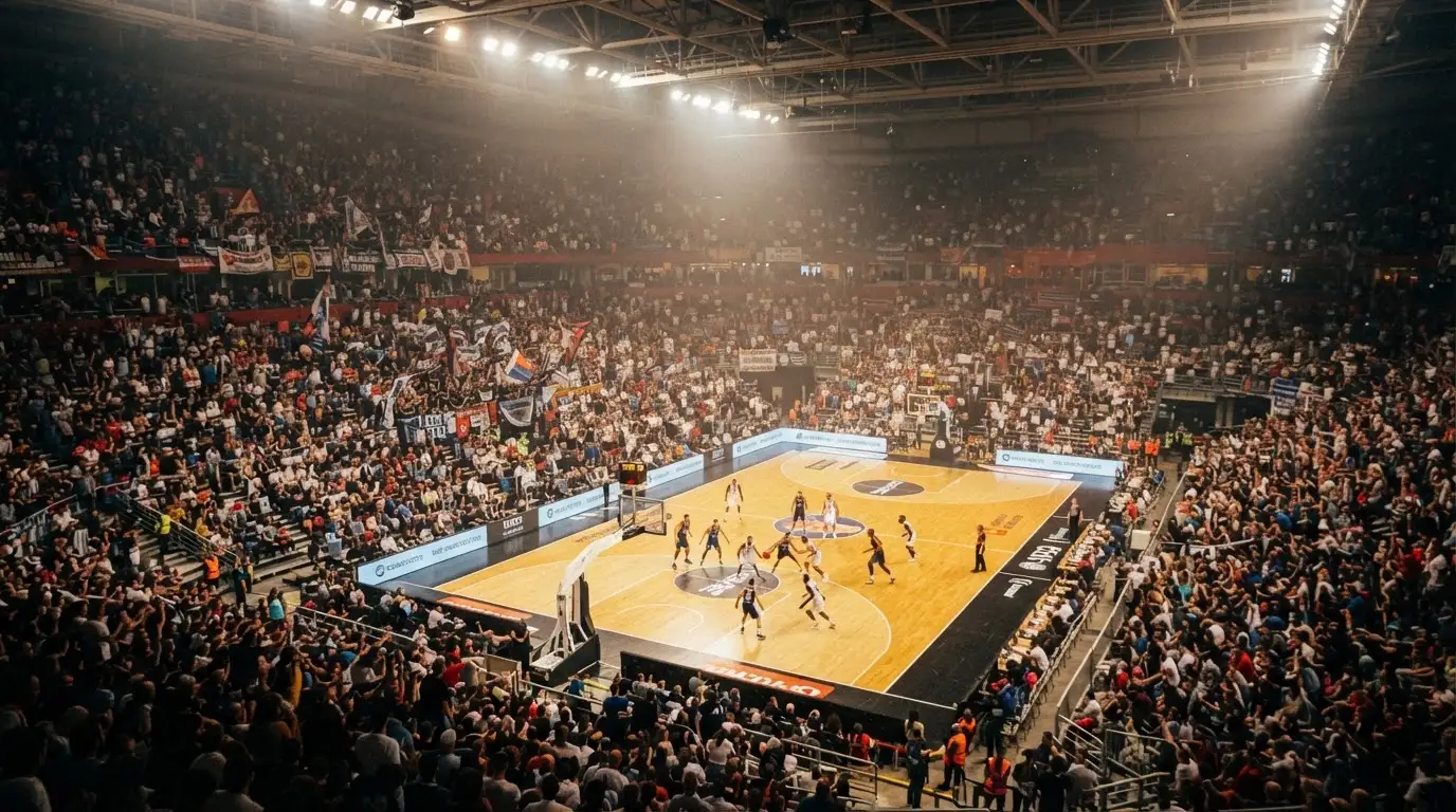 Un pabellón deportivo lleno bajo los focos, fotografiado desde muy lejos